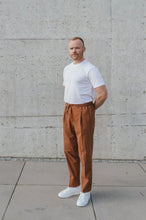 Laden Sie das Bild in den Galerie-Viewer, Full body view of model in rust Japanese seersucker drawstring trousers with a single pleat