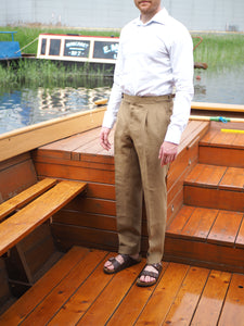 Light brown linen trousers with pleated front and side adjusters