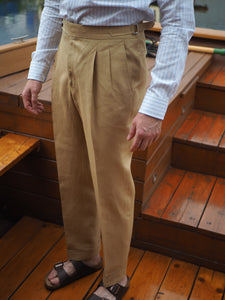 Double pleats and side adjusters adds sophistication to the summer essential trousers made from irish linen