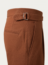 Load image into Gallery viewer, Close-up view of the adjustable Gurkha waistband, silver-tone buckle closure, side seam construction, and the signature puckered texture of our brown seersucker fabric.