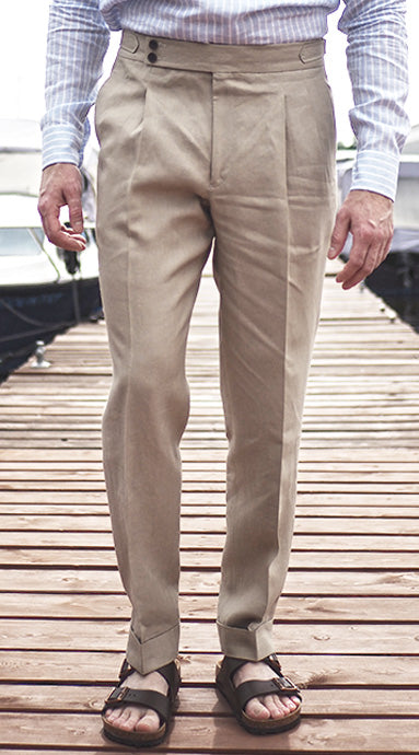 Double pleated Spence Bryson linen trousers with side adjusters and high rise, present wide double button waist as its sartorial touch.